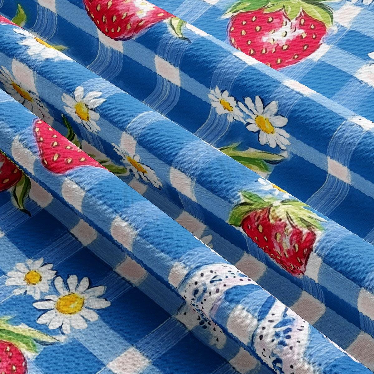 a blue and white checkered table cloth with strawberries on it