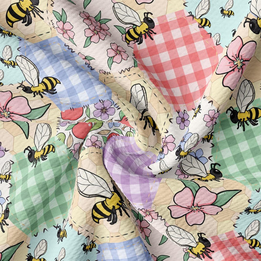 a multicolored checkered fabric with bees and flowers
