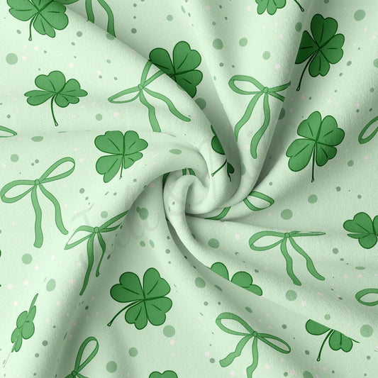 a green and white fabric with shamrocks on it