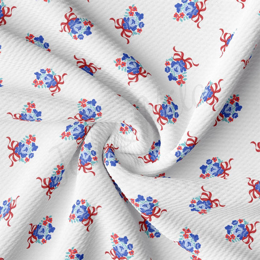 a white fabric with red and blue flowers on it