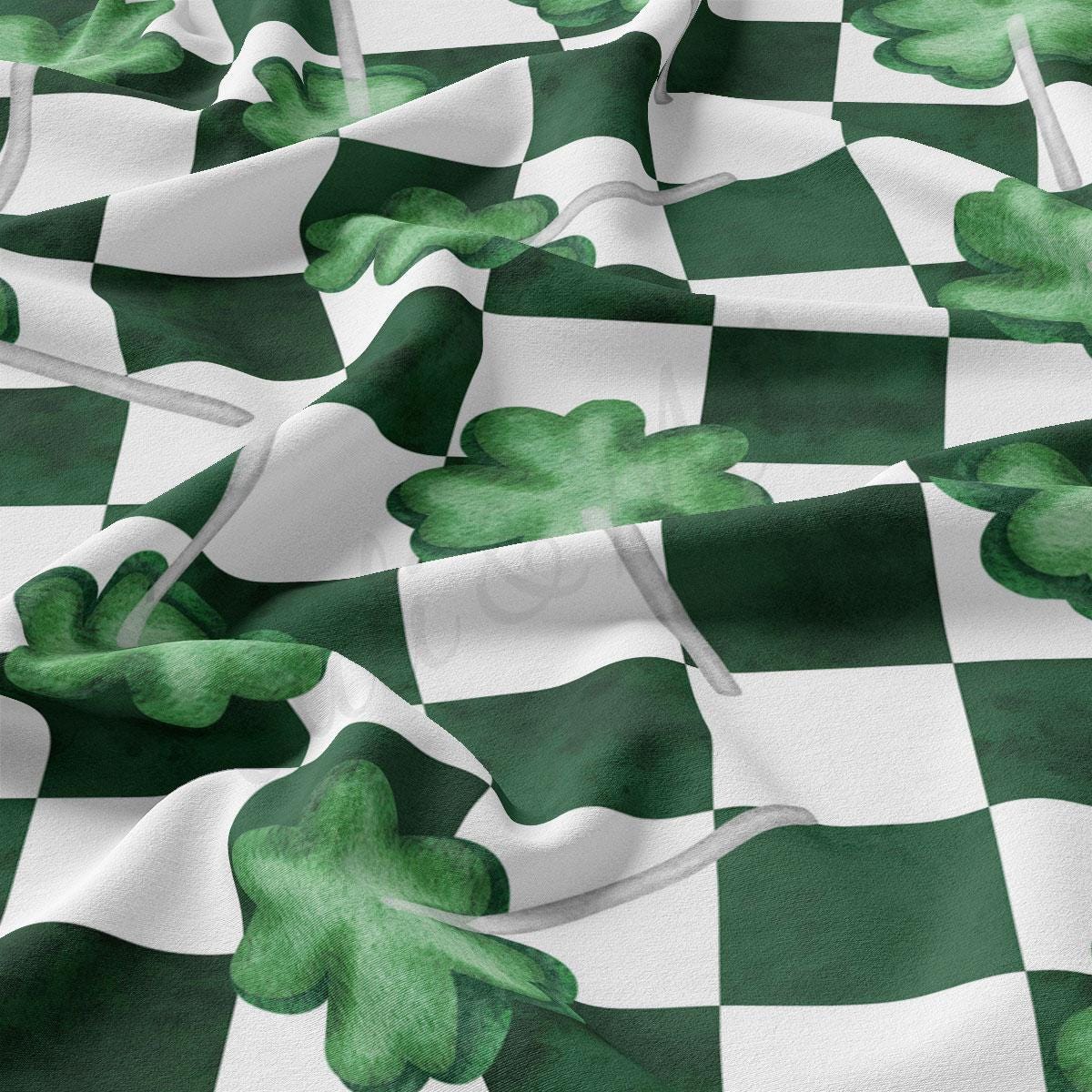 a green and white checkered fabric with shamrocks on it