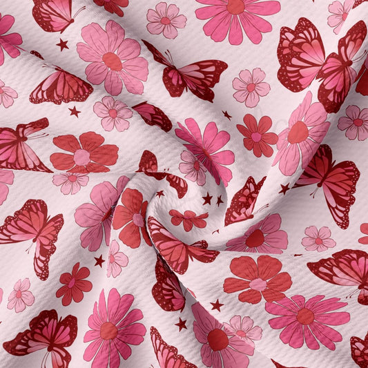 a pink and red flower and butterfly print fabric