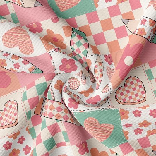 a pink and green checkered fabric with hearts on it