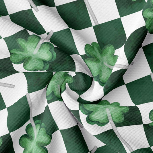 a green and white checkered fabric with shamrocks on it