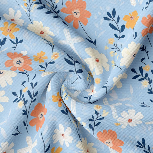 a blue floral print fabric with orange and yellow flowers