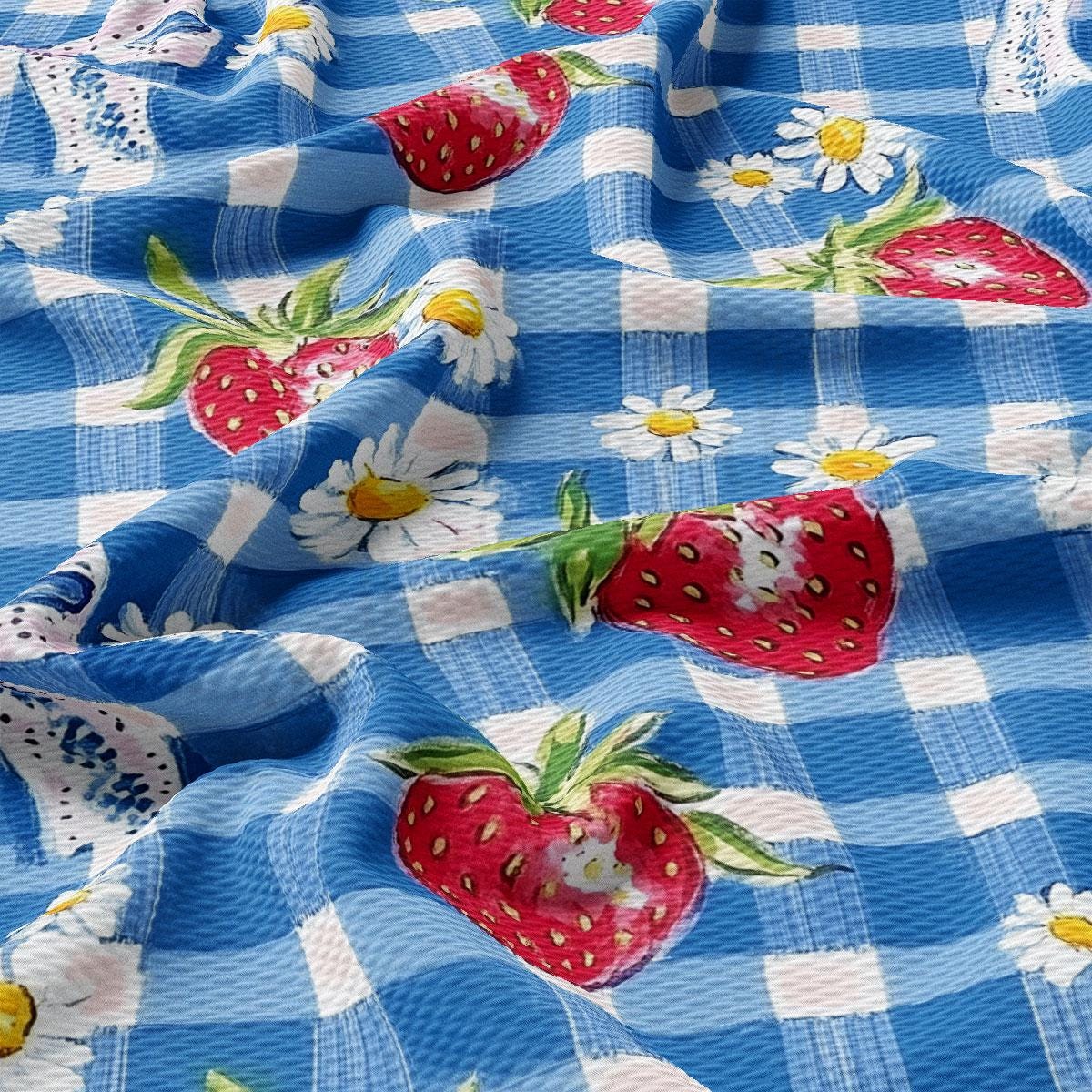 a blue and white checkered fabric with strawberries on it
