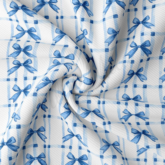 a blue and white checkered fabric with bows