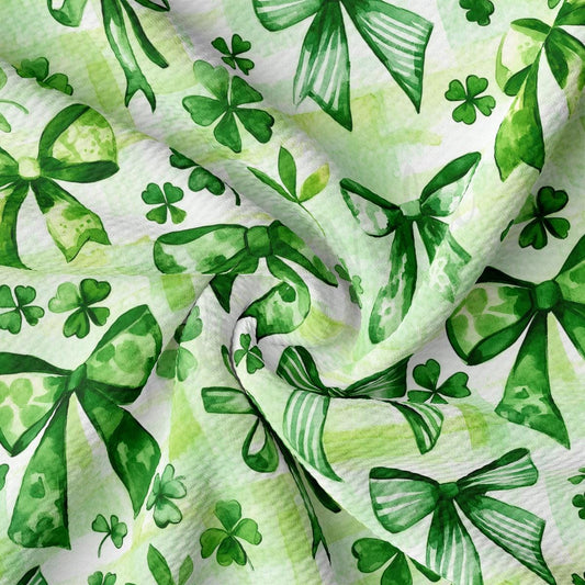 a green and white background with shamrock leaves