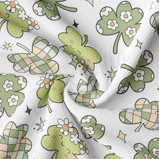 a close up of a white fabric with shamrocks on it