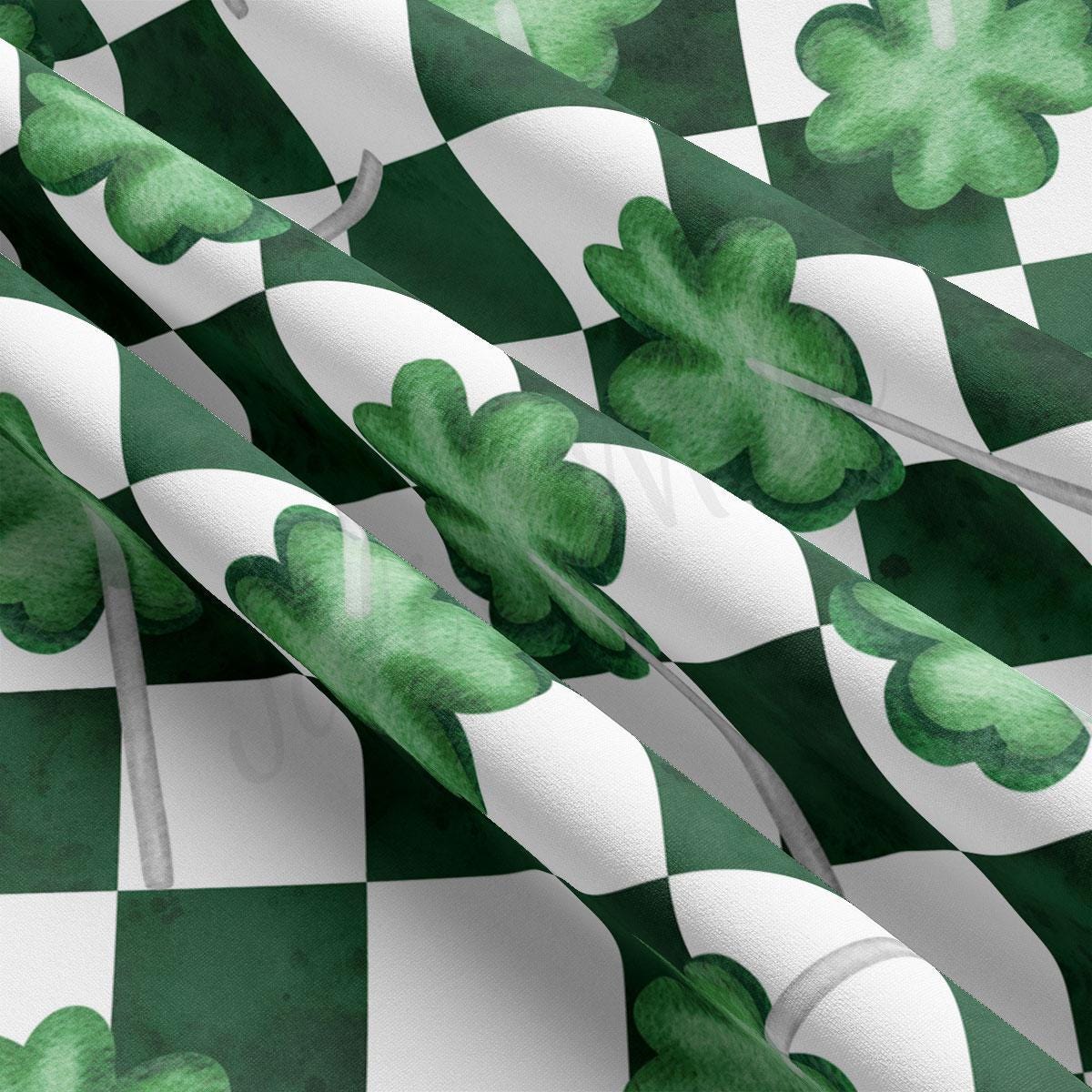 a green and white checkered fabric with shamrocks on it