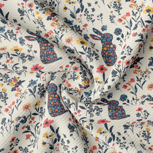 a white fabric with flowers and rabbits on it