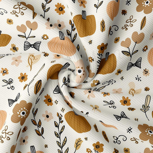 The image is a close-up view of a fabric with a repeating pattern of autumn-themed elements, including pumpkins, leaves, flowers, and other decorative motifs.