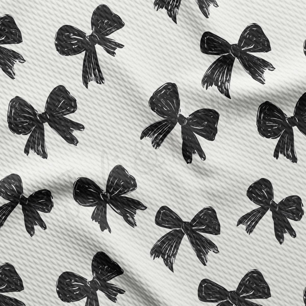 a repeating pattern of black bows on a white background.