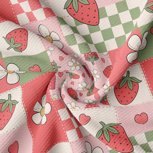 a pink and green checkered fabric with strawberries on it