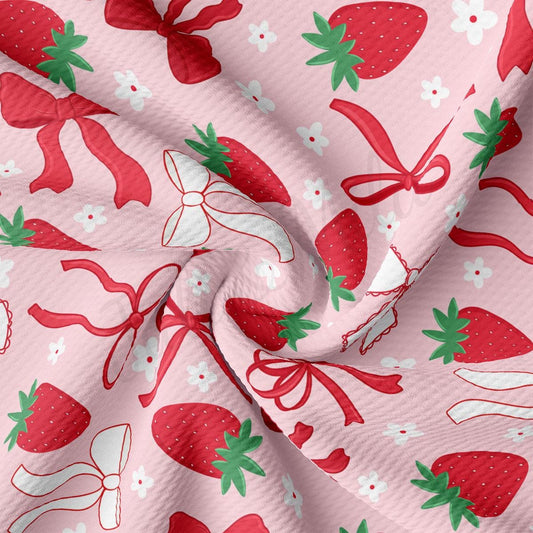 a close up of a pink fabric with strawberries on it