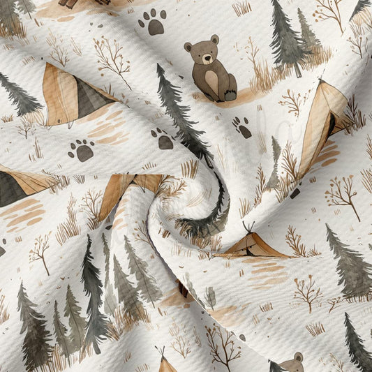 a close-up view of a fabric with a repeating pattern of camping tents, pine trees, and a teddy bear.