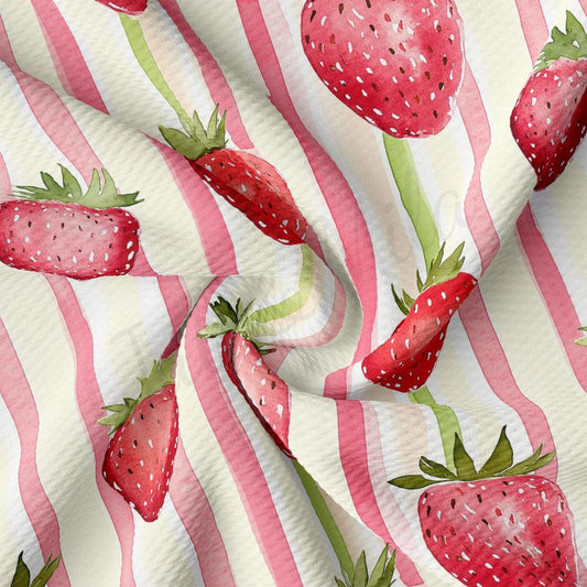 a pink and white striped fabric with strawberries on it