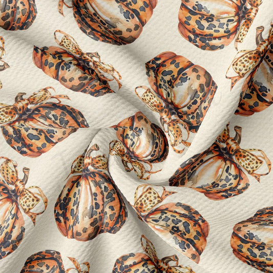 a repeating pattern of leopard print pumpkins on a white background.