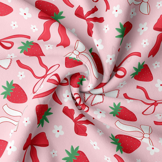 a close up of a pink fabric with strawberries on it