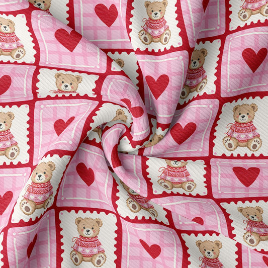 The image is a close-up of a fabric with a repeating pattern of pink and white checkered squares, each containing a teddy bear wearing a pink sweater and a red heart.