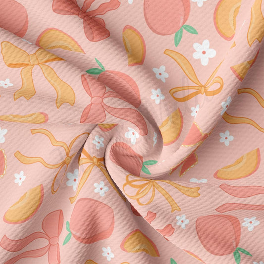 a close up of a pink fabric with oranges and flowers