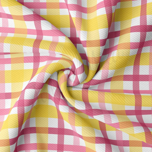 a pink and yellow checkered fabric with a white background