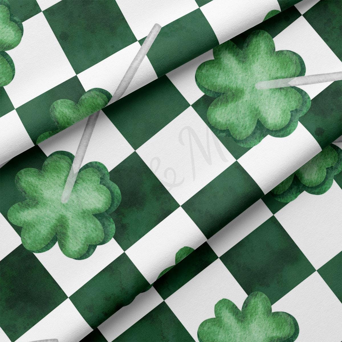 a green and white checkered pattern with shamrocks