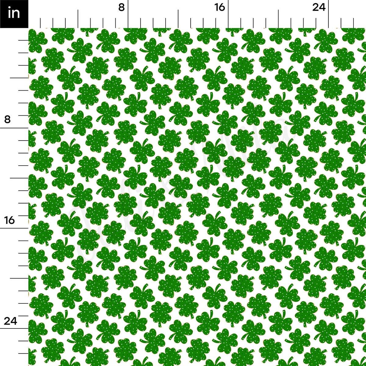 a green and white pattern with four leaf clovers