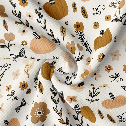 The image is a close-up of a fabric with a repeating pattern of pumpkins, flowers, and leaves in various shades of brown and beige.
