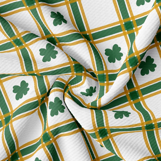 a green and yellow plaid fabric with shamrocks on it