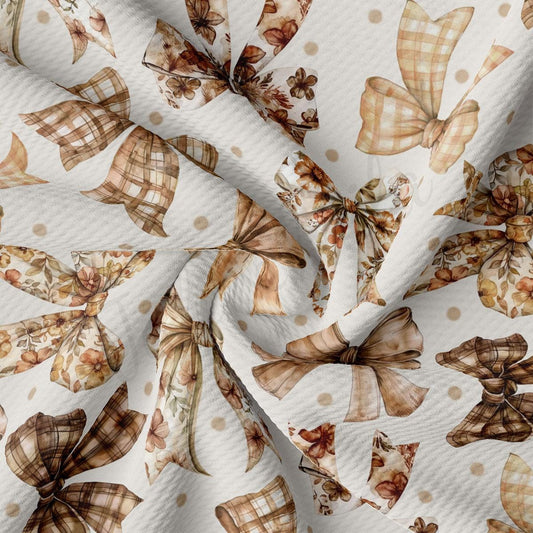 The image is a close-up view of a fabric with a repeating pattern of brown and white bows and flowers, creating a visually appealing and textured design.