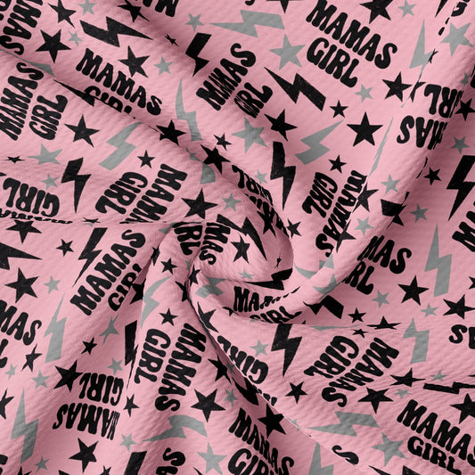 a pink fabric with black stars on it