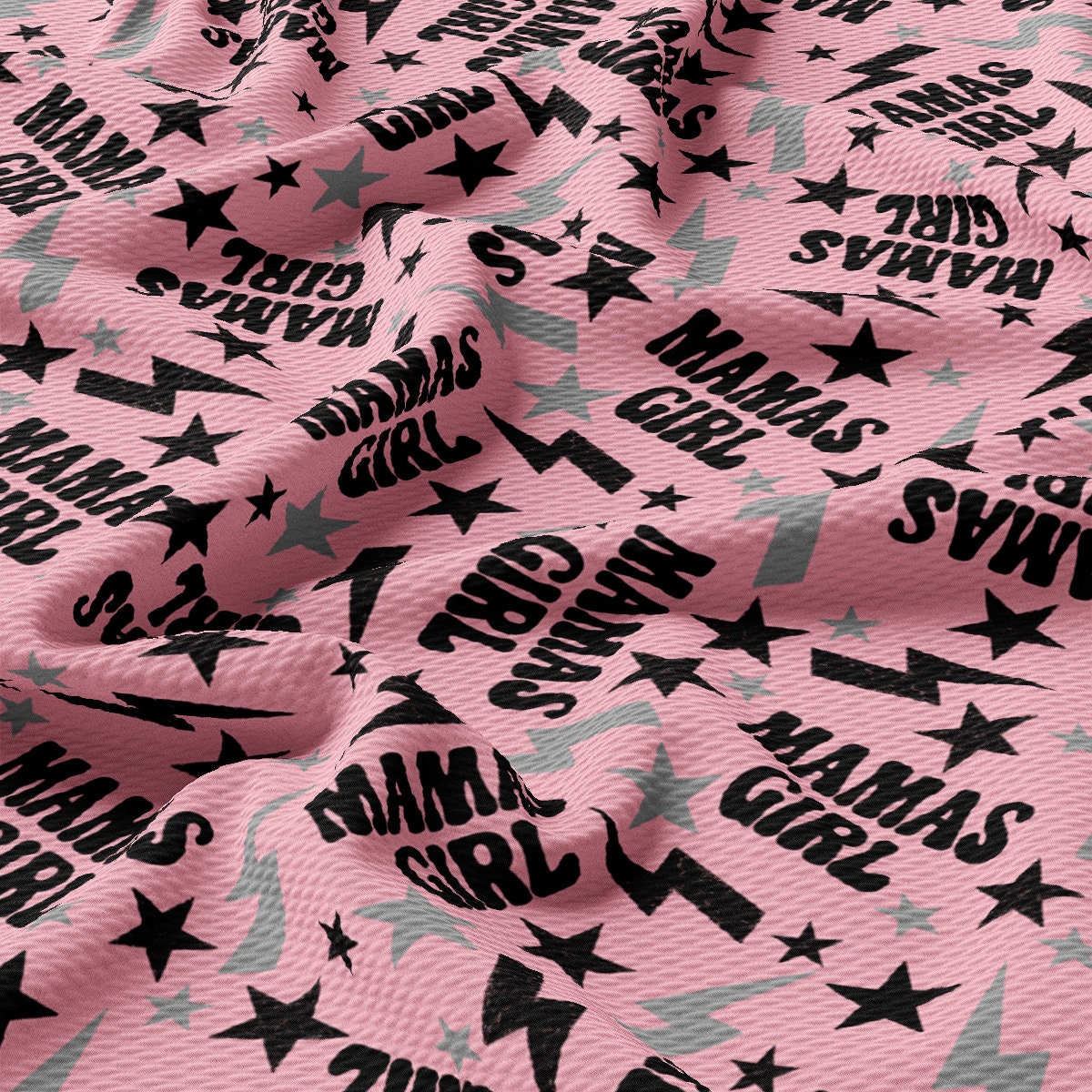 a pink fabric with black stars on it