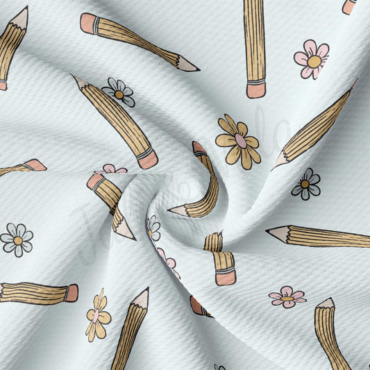 a white fabric with pencils and flowers on it