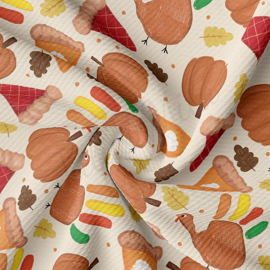 a close up of a white fabric with a pattern of leaves and acorns