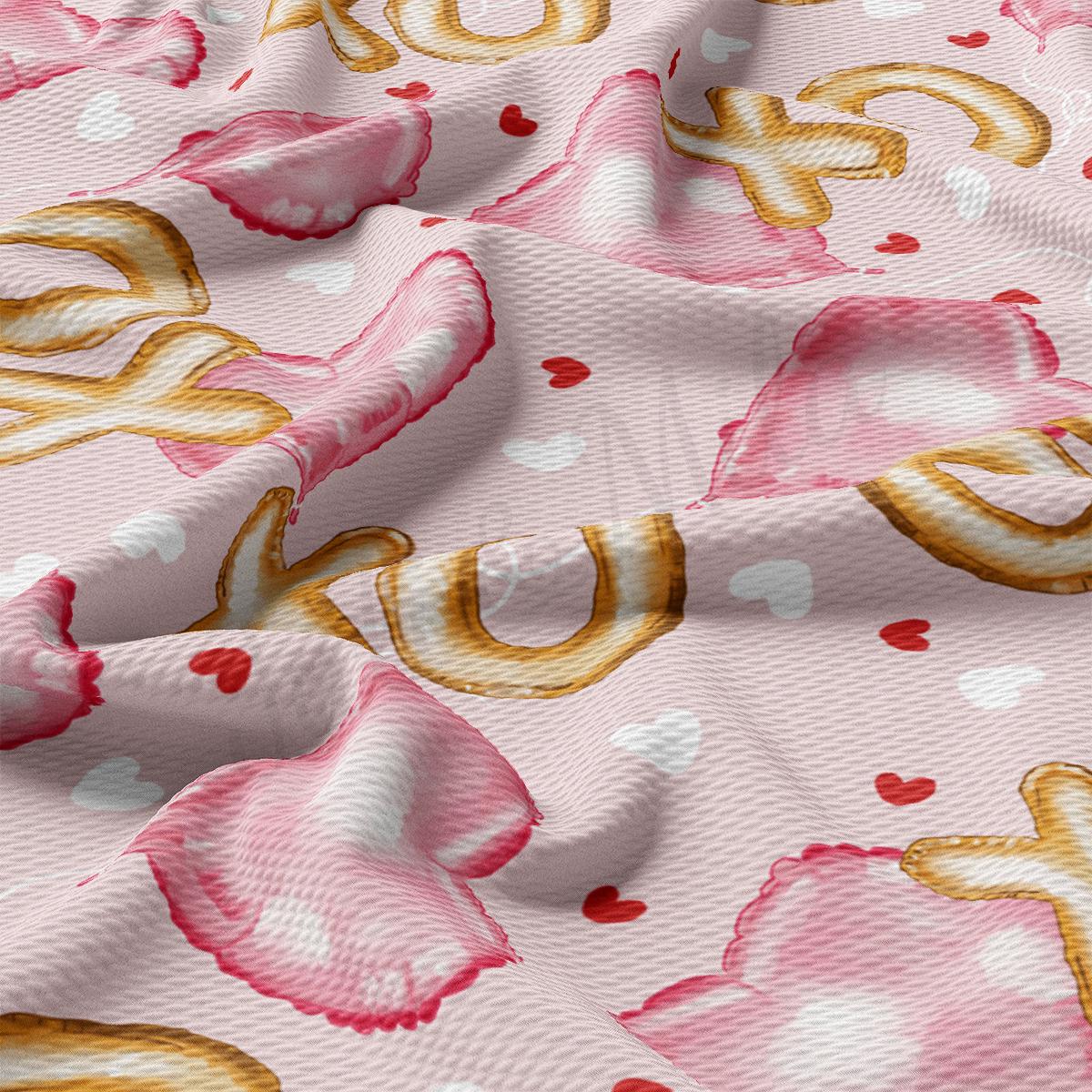 a close up of a pink and gold fabric