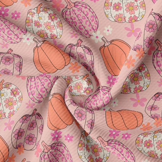 a pink background with a pattern of pumpkins and flowers