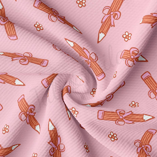a pink fabric with guns and flowers on it