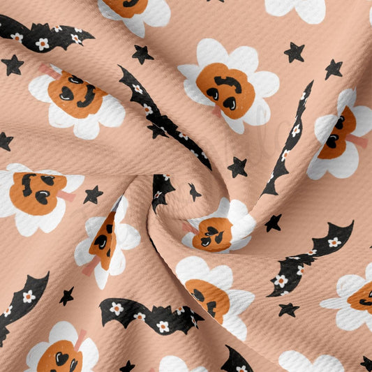a pattern of cats and bats on a pink background