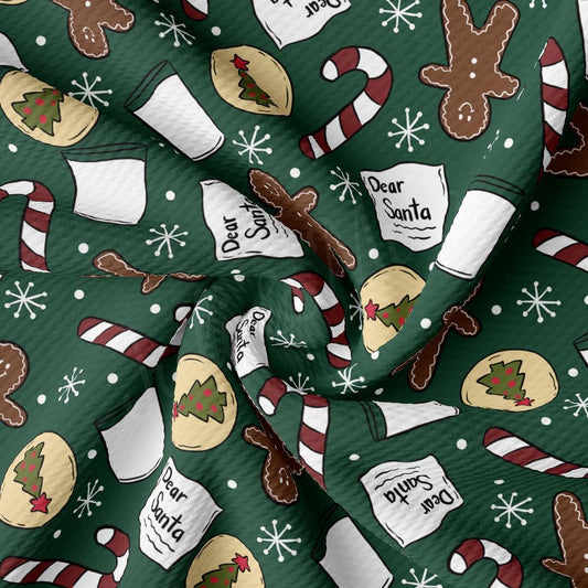 a green christmas fabric with gingerbreads and candy canes