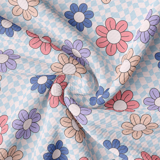 a close up of a blue and pink flowered fabric