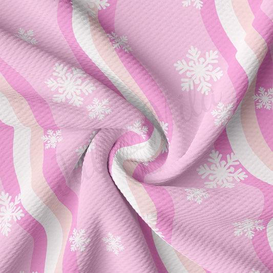 a pink and white fabric with snowflakes on it