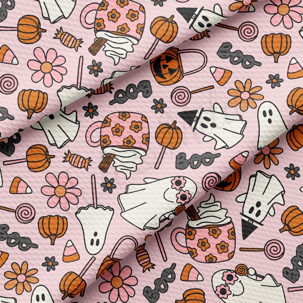 a pink background with a pattern of halloween items