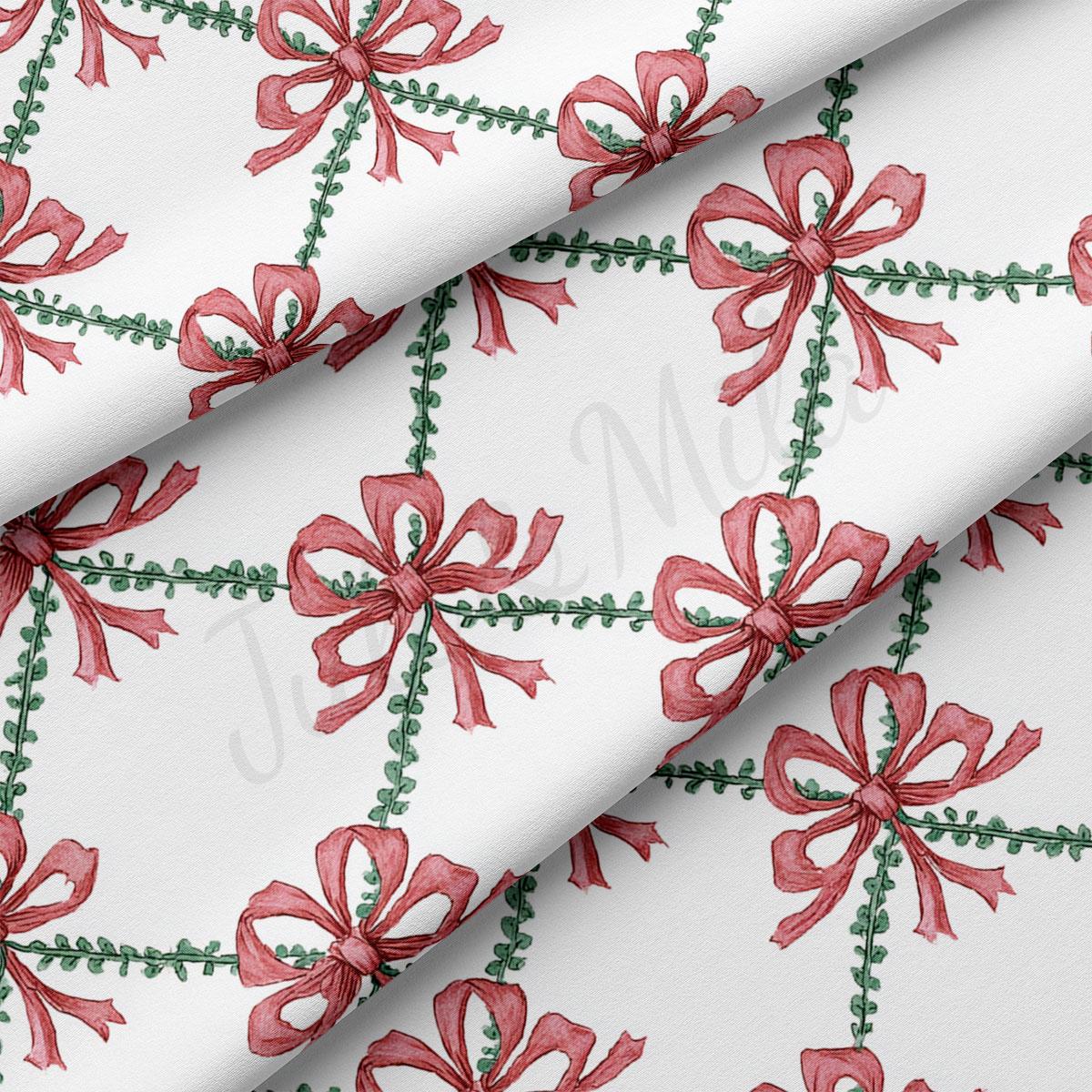 a repeating pattern of red bows with green leaves on a white background.