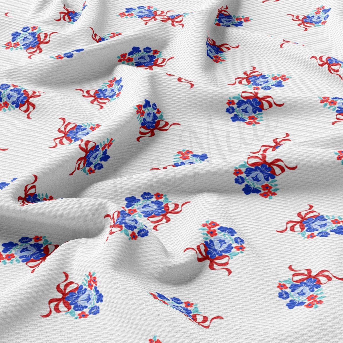 a white fabric with red and blue flowers on it