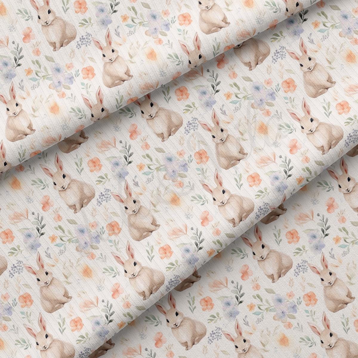 a close up of a fabric with flowers and rabbits on it