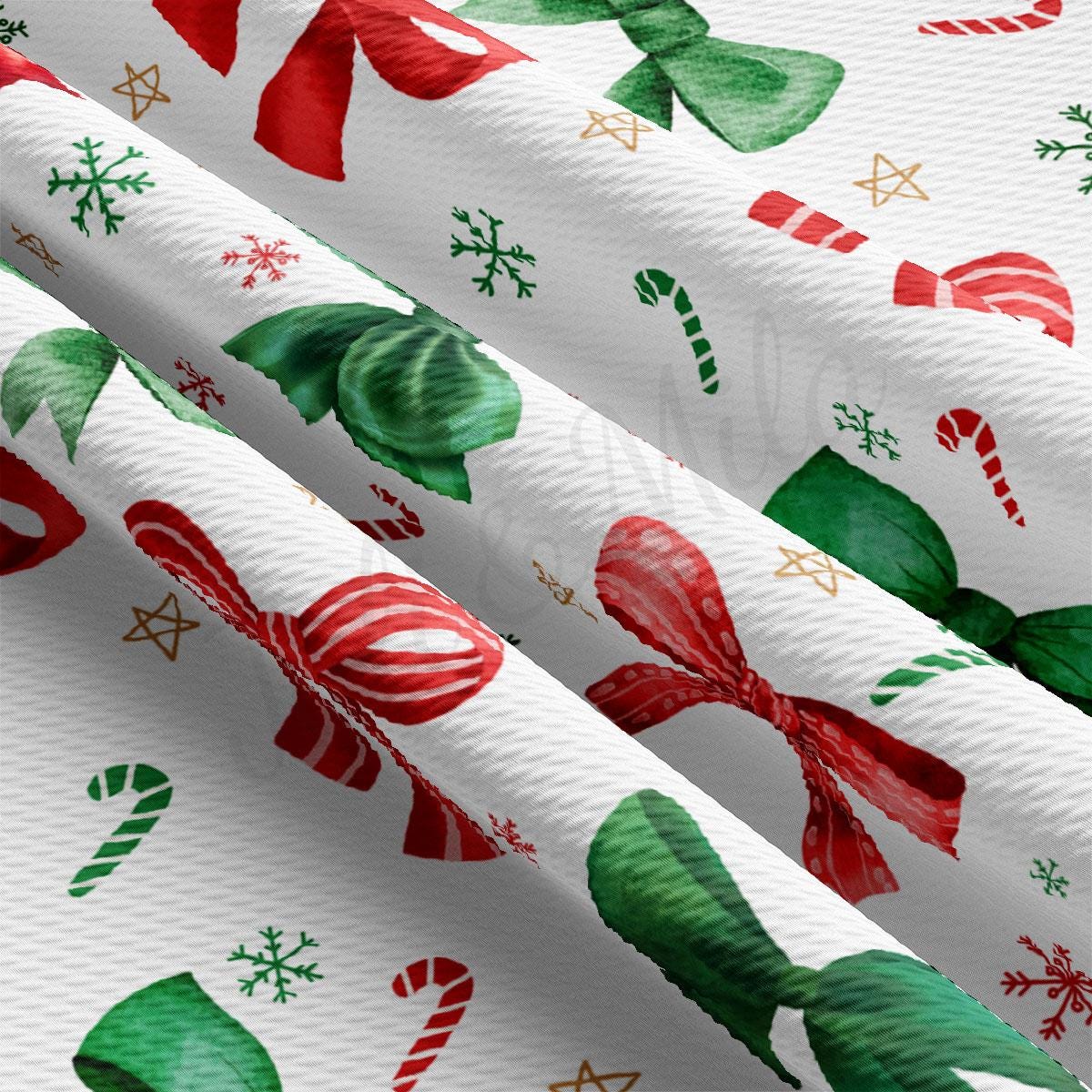 a close-up view of a fabric with a repeating pattern of red and green bows, snowflakes, and candy canes.