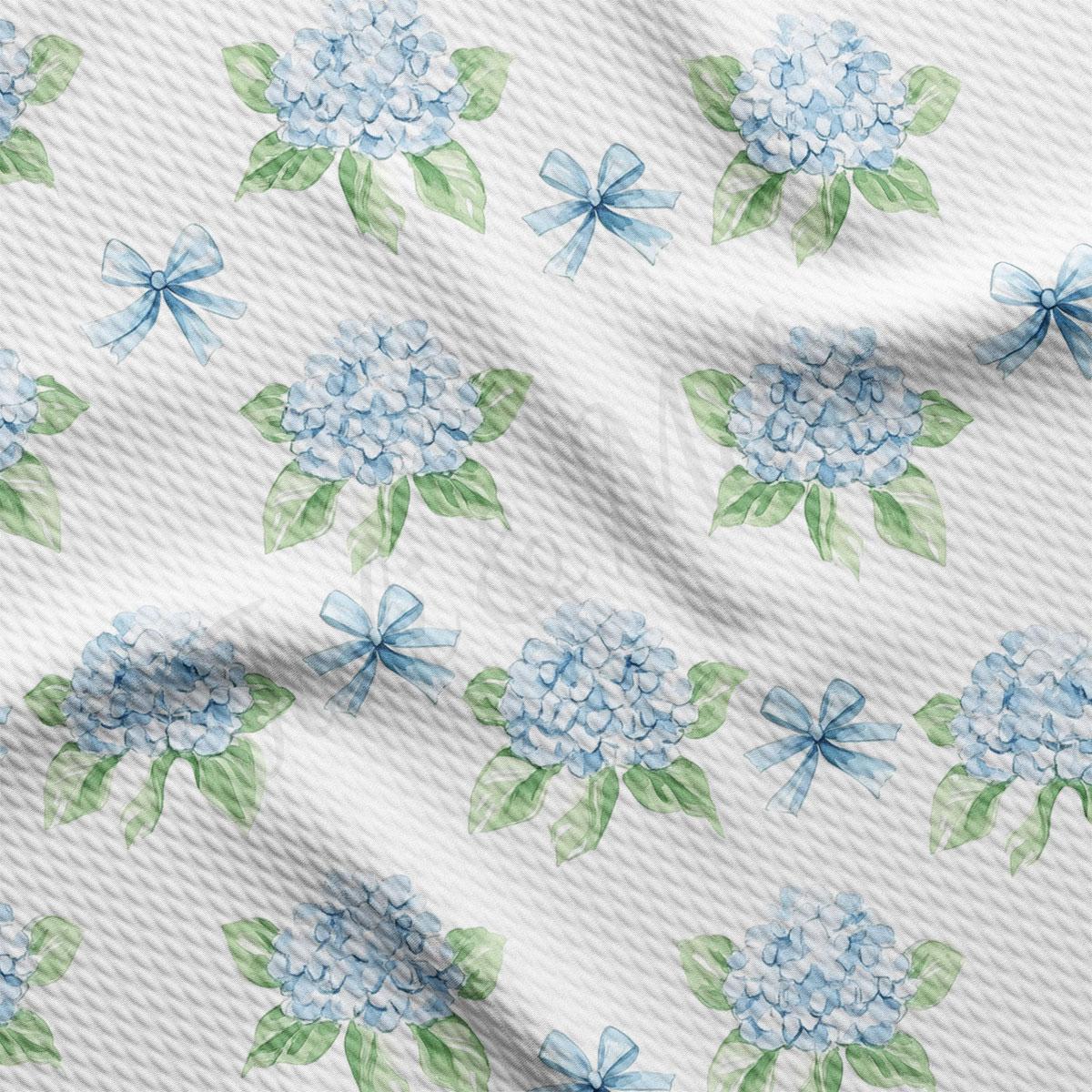 a repeating pattern of blue hydrangea flowers with green leaves and bows on a white background.