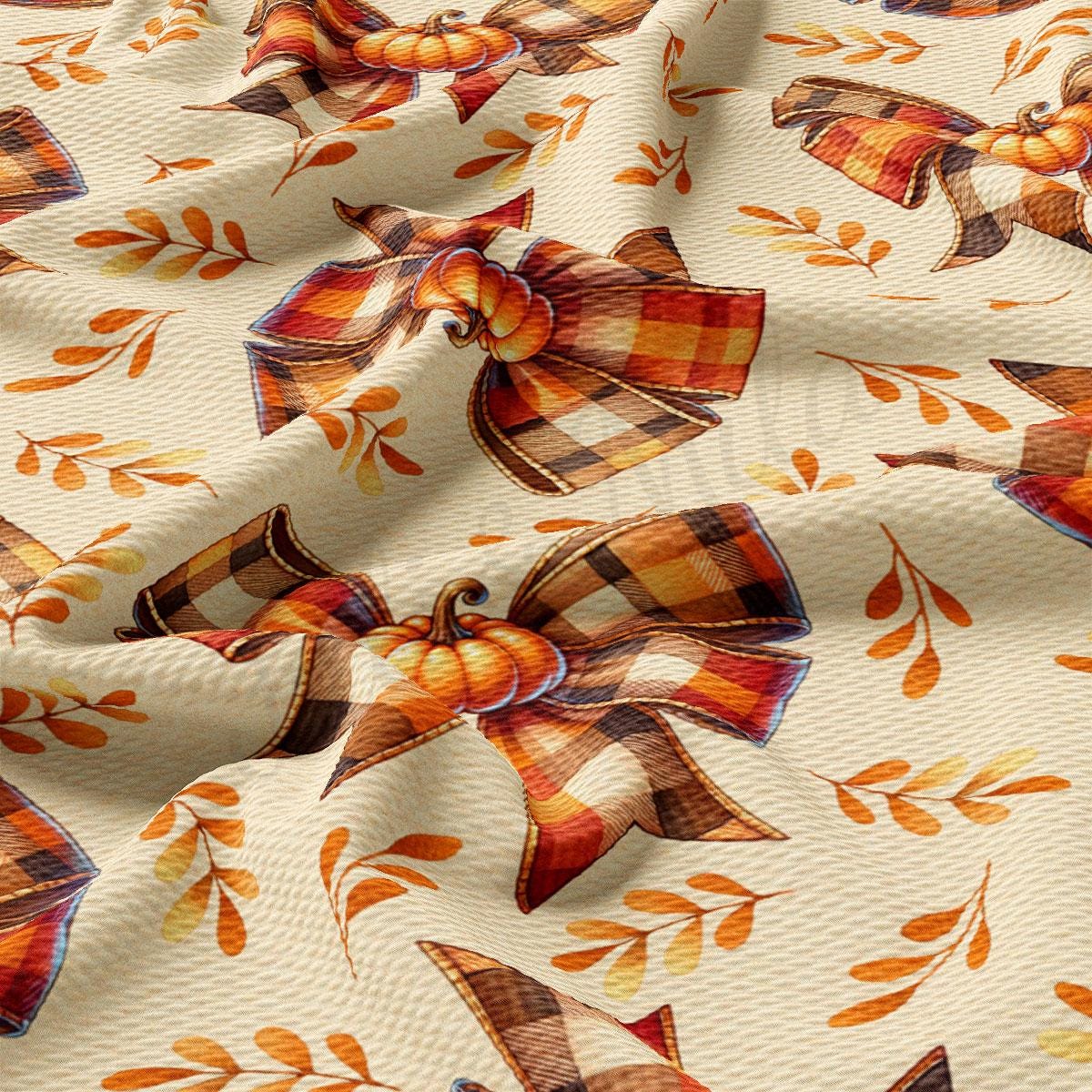 a close-up view of a fabric with a repeating pattern of autumn leaves and pumpkins, along with bows. The pattern is predominantly orange and brown, creating a warm and cozy atmosphere.