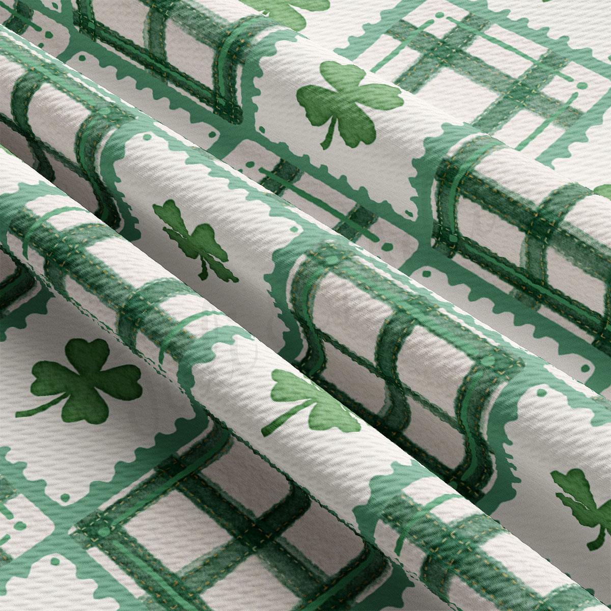 a close-up view of a fabric with a repeating pattern of green shamrocks on a white background.